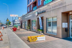 A building with a storefront labeled "Diversecities" and a sign for "Crystal Glass" across the street.