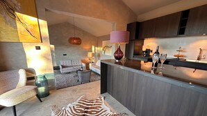 A modern kitchen with a bar area, a zebra-patterned rug, and a dining area with a sofa and chairs. - 2-bedroom Poolvilla in Rovinj with cool AC breeze (Rovinj)