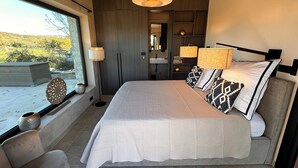 A modern bedroom with a large bed, bedside lamps, a view of the outdoors, and a built-in wardrobe. - 2-bedroom Poolvilla in Rovinj with cool AC breeze (Rovinj)