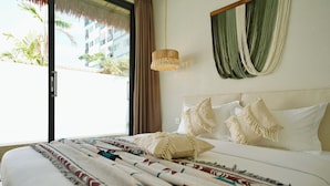 A hotel room with a bed, a hanging light fixture, a view of palm trees, and a curtain. - MaShang Holiday Villas - Luxury 5BR Private Pool Villa in Jomtien (Muang Pattaya)