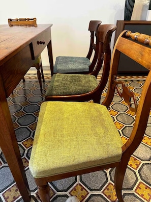 A wooden dining table with a drawer and a chair with a green cushion. - Rhome Elegant Apartment (Roma)