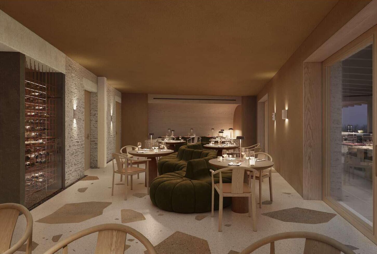 Un espace repas moderne avec des tables rondes, des sièges recouverts d’un tissu vert et un meuble à vin.