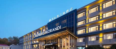 A hotel with a modern facade, large windows, and a prominent signage.