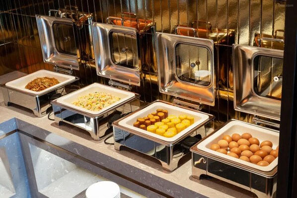 A buffet with various food items in metal containers. - Giorgio Morandi Hotel - Langfang Wanda Plaza (Langfang)