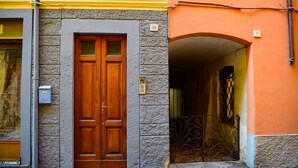 Un bâtiment doté d’une porte double en bois, portant le numéro 35, et d’un portail en métal orné d’un motif décoratif.