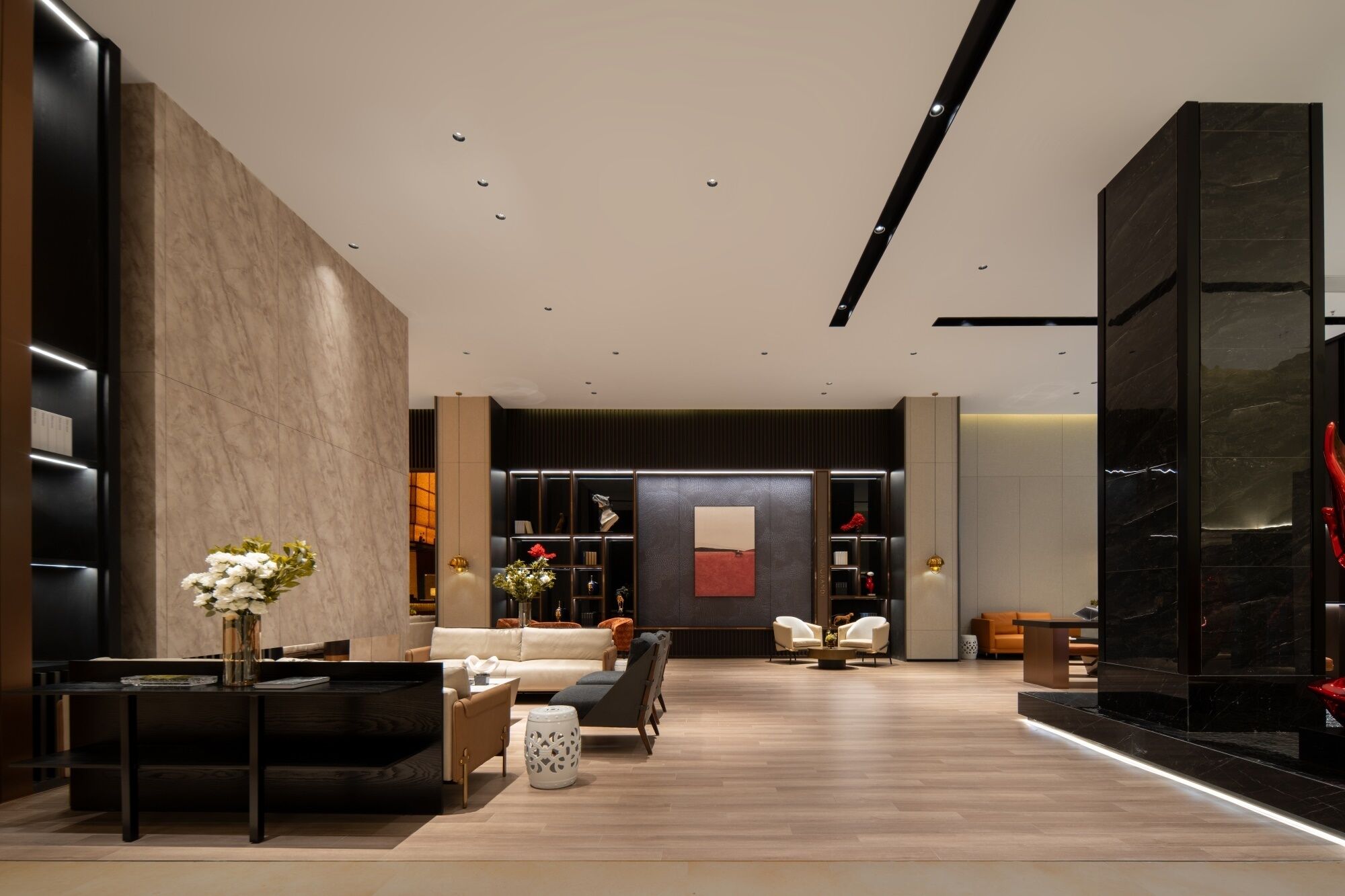 A modern interior with a sofa, a coffee table, a fireplace, and a wall with a framed picture.