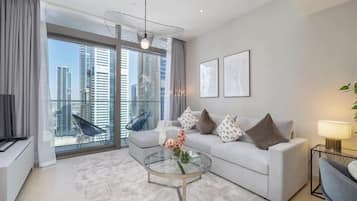 Luxury Apartment, Balcony, City View | Living area | 65-inch Smart TV with cable channels