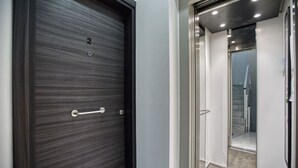 A modern elevator with a metallic interior and a glass door. - Sofia`s Designer Apartment (St. Julian`s)