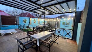 An outdoor patio with a table and chairs, a barbecue grill, and a pool. - Cozy A-Frame house in Gabala.
Nature retreat with mountain view and Heated pool (Gebele)
