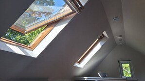 A room with skylights allowing natural light to enter. - The Smarden Snug for Garden Lovers (Ashford)