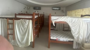 A dormitory room with bunk beds, a ceiling light, and a window. - Hostel Suites (Recife)