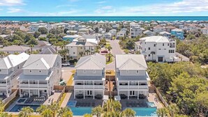 A coastal residential area with multiple two-story houses, each featuring a front yard and a swimming pool. - Modern 3-story Beach House W Poll and Billiard (Miramar Beach)