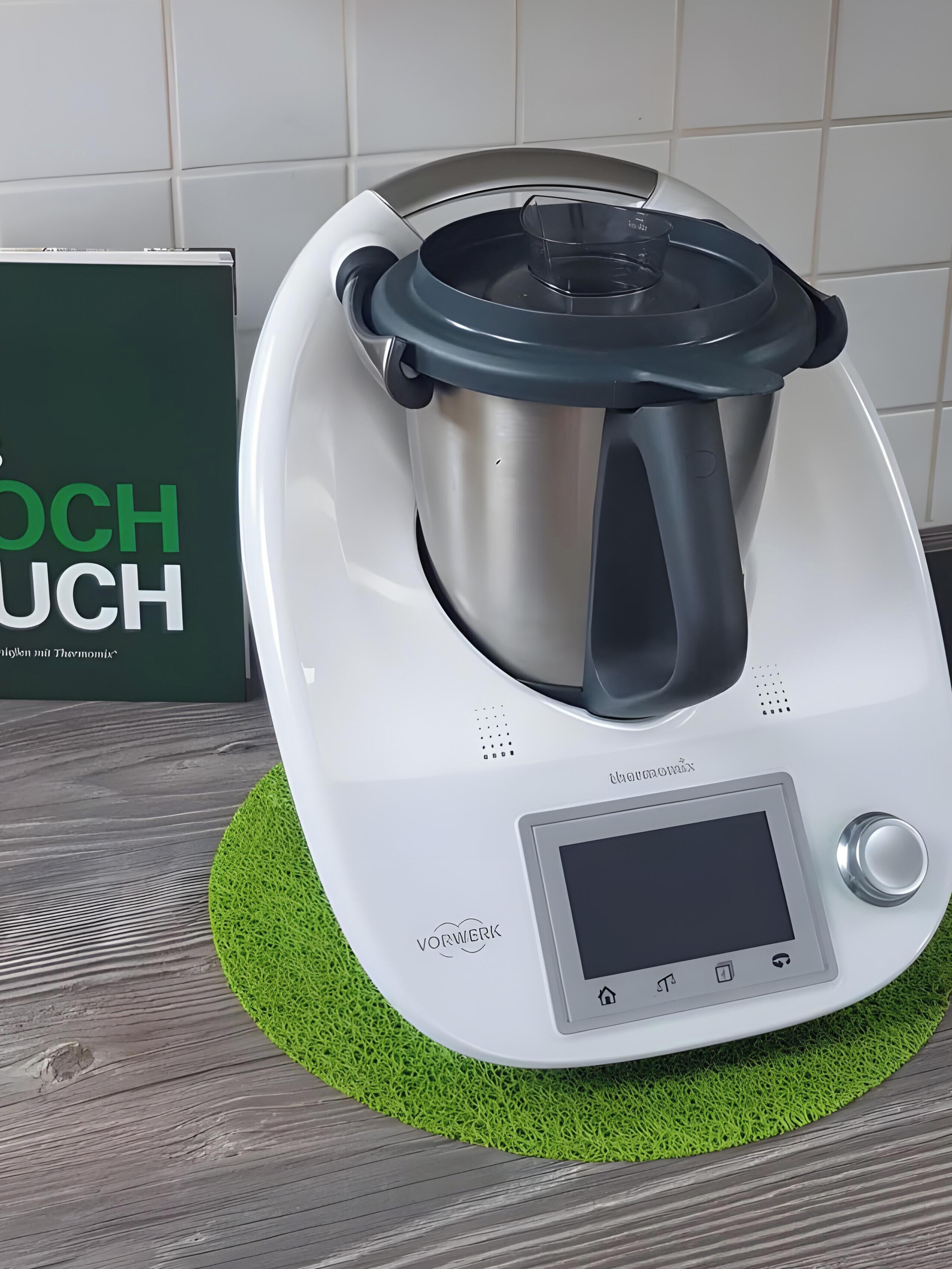 A kitchen appliance with a digital display, a control knob, and a stainless steel pot.