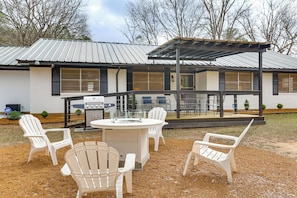 An outdoor patio with a grill, white chairs, and a covered seating area. - Hike, Fish & Swim: Nat'l Forest Home in Crockett (Kennard)