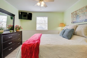 A bedroom with a bed, a dresser, a TV, a window, and a painting. - Peace & Relaxation at Texas Countryside Tiny Home (Bowie)