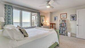 A bedroom with a large bed, a ceiling fan, a bookshelf, and a view of the outdoors. - < 1 Mi to Port Clyde Village: Modern Retreat (Tenants Harbor)