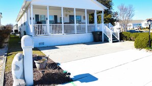 A single-story house with a covered porch, a front yard, and a driveway. - Montego Bay-Colonial Drive 13339-Bayside 135th Street (pets allowed) (Ocean City)