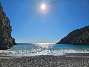 A coastal beach with rocky cliffs and clear blue sea. - EL-LU 2 Villa with breathtaking 360-degree seaview and a private pool (Kamilari)