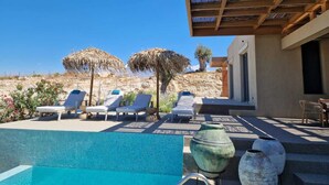A pool area with lounge chairs and a pergola. - EL-LU 2 Villa with breathtaking 360-degree seaview and a private pool (Kamilari)