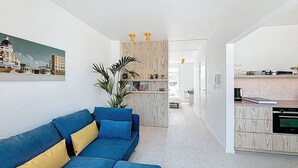 A modern living room with a blue sofa and a wooden cabinet. - Casa Vento -  Koksijde (Koksijde)
