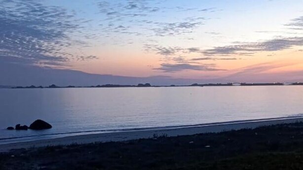 A calm body of water with a distant shoreline and a clear sky. - Vionta: Your cozy retreat with garden view near the beach (Aguiño)