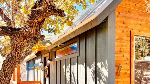 A wooden cabin with a staircase leading to a door marked with the number 7. - Cozy Cabin w a view & Tesla EV Charger (Dripping Springs)