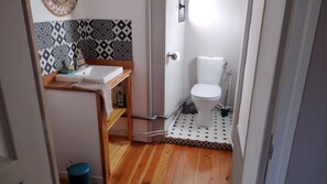 A small bathroom with a white toilet, a sink, and a shower. - Holiday Home 'La Maison De Béatrice' with Mountain View, Private Terrace and Wi-Fi (Oberbruck)