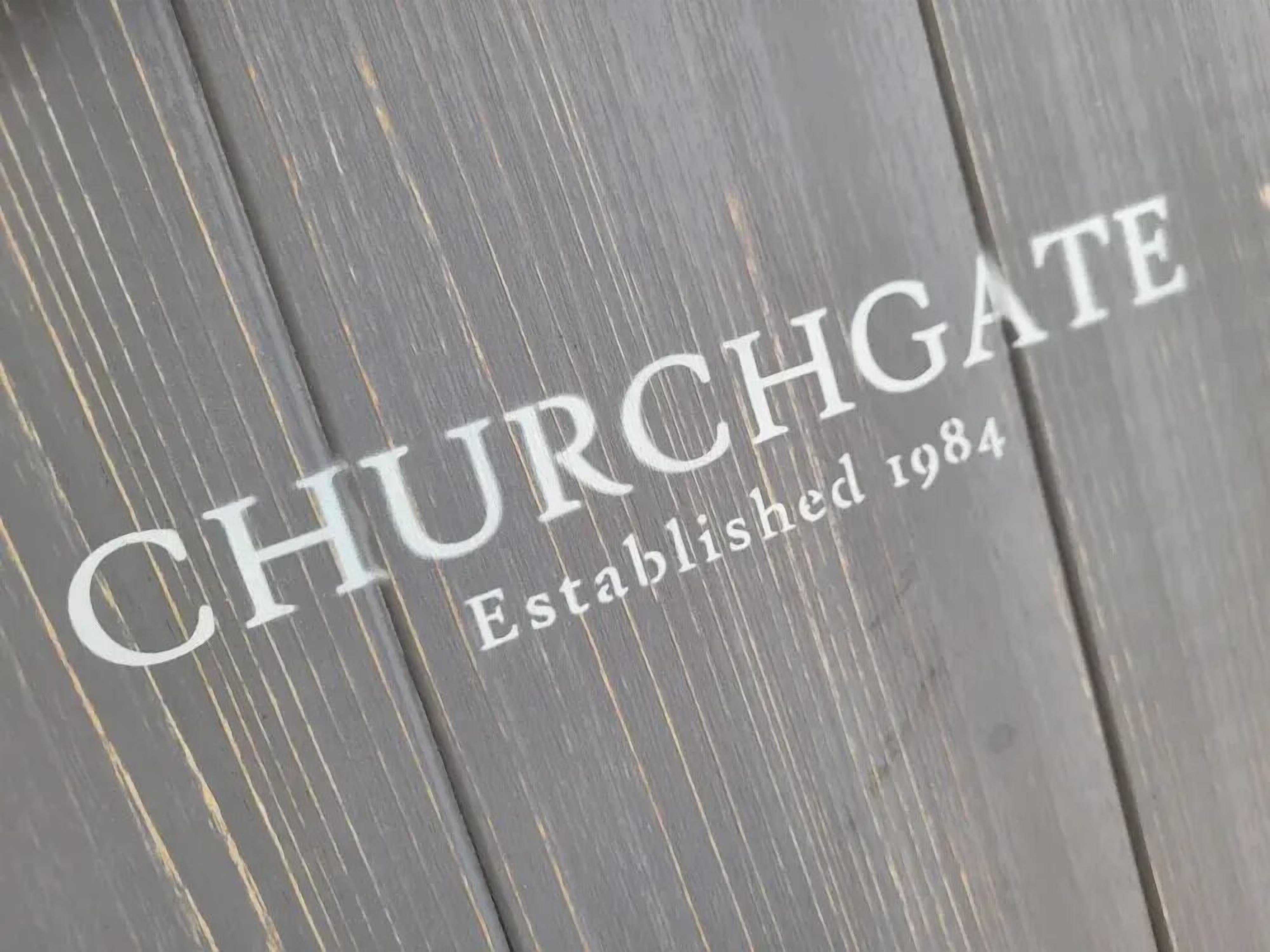 A wooden surface with the text "CHURCHGATE Established 1984".