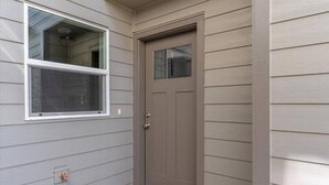 A house with a front door, a window, and a small porch area. - Modern 3BR Salem Retreat in Quiet Neighborhood (Salem)