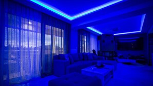 A modern living room with a sectional sofa, a coffee table, and a flat-screen TV. - DimArist Residence in Zakynthos (Agios Kirikos)