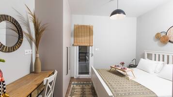 1 bedroom, desk, iron/ironing board, travel crib