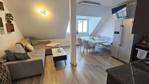 Ein modernes Apartment mit Wohnbereich, Essbereich und Küche.