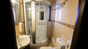 A bathroom with a glass-enclosed shower, a sink, a toilet, and a mirror. - Private Jaccuzzi Suite (Kryonérion, limni plastira, karditsa)