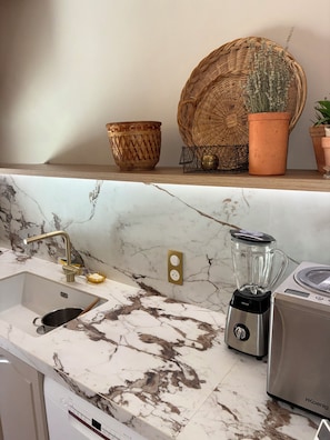 A kitchen with a marble countertop, a sink, a blender, and a dish rack. - 4-bedroom villa with a private padel court, pool, and petanque court   (Le Muy)