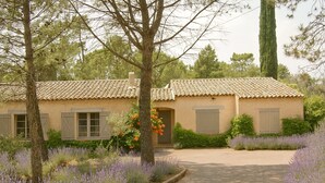A rustic house with a tiled roof, surrounded by lavender fields and trees. - 4-bedroom villa with private pétanque pool and padel court (Le Muy)