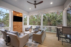 A covered outdoor area with wicker furniture, a ceiling fan, and a sign reading "FRIPP". - Lagoon View, Golf Cart Included - 215 Deer Run (Fripp Island)