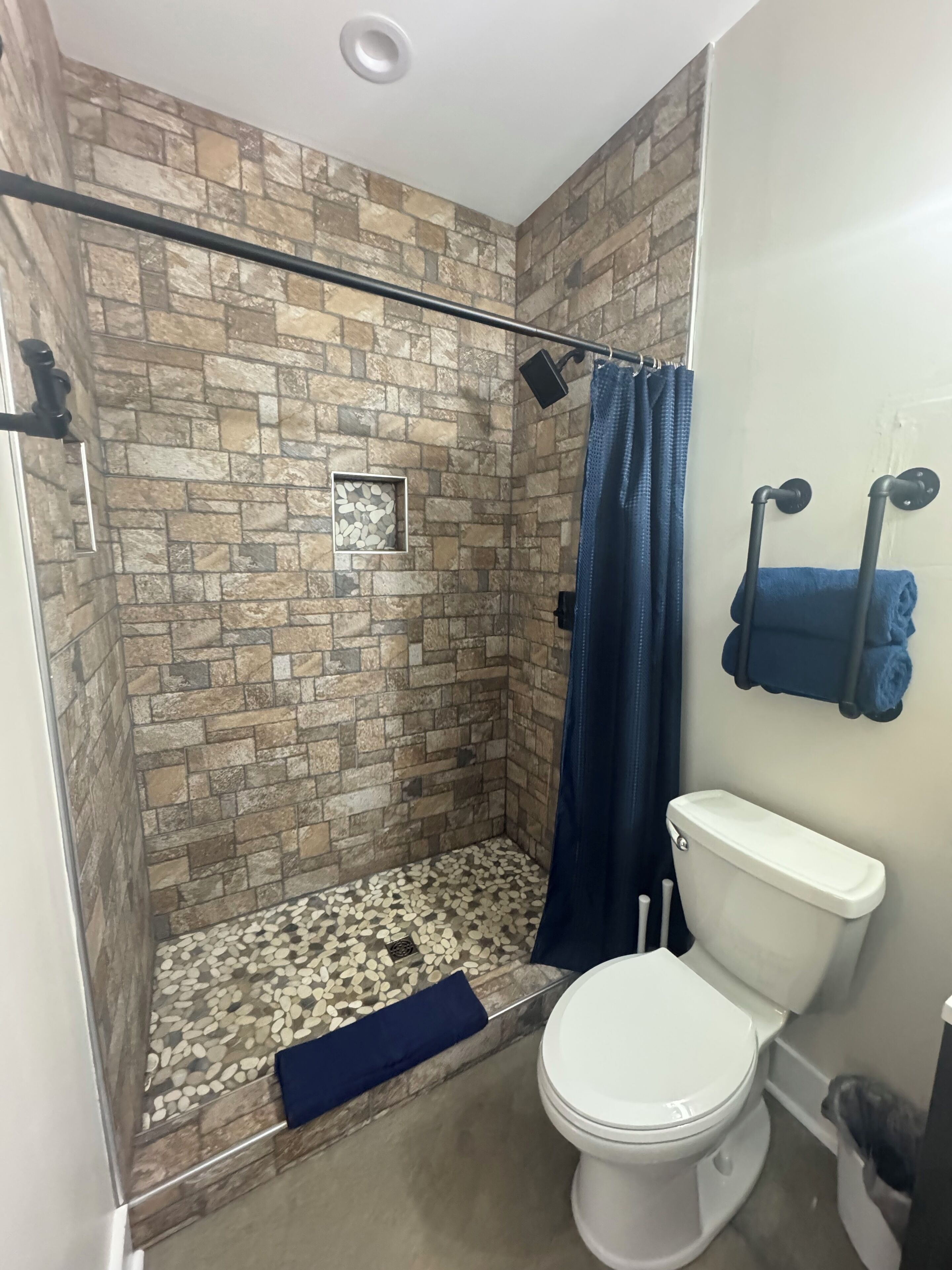 Shower, hair dryer, towels, toilet paper