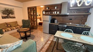 A compact living space with a kitchenette, a dining area, and a seating area. - Athenian Stay 301 By VPN (Athens)