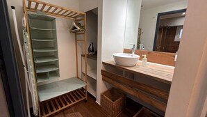 A bathroom with a wooden vanity, a white sink, and a mirror. - Athenian Stay 301 By VPN (Athens)