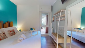 A bedroom with a white bed, a wooden ladder, and a small table with a lamp. - Sirmio Green Shore By Bookinggardalake (Sirmione)