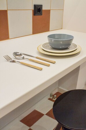 A kitchen counter with a bowl, a spoon, and a fork. - Acropolis Luxury retreat (Athens)