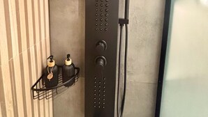 A modern shower with a control panel, a handheld showerhead, and a handheld faucet. - Monastiraki 110 @SuperHost Hub (Athens)
