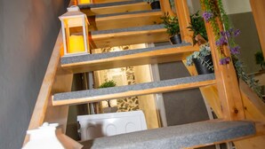A wooden staircase with a handrail, a lantern, and potted plants. - Archontissa House - Sea View (Mesongi)