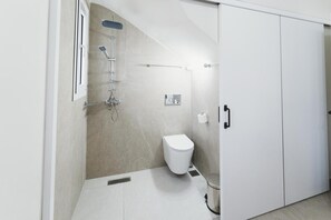 A modern bathroom with a shower, toilet, and a cabinet. - Aiolia Villa in Rhodes (Rhodes)