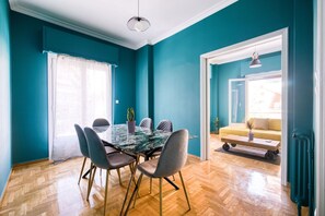 A dining area with a glass table, chairs, and a potted plant. - Sunny 2 bedroom  cozy apartment, view of Parthenon (Athina)