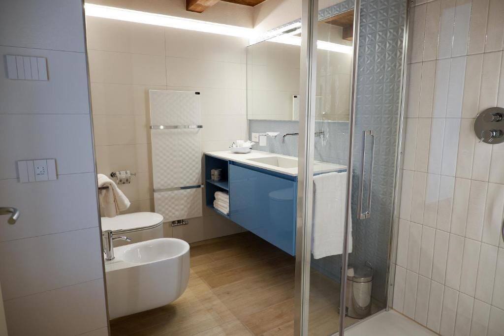 A modern bathroom with a bathtub, a shower, and a sink.