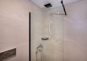 A modern shower with a glass enclosure, a handheld showerhead, and a wall-mounted faucet. - Casa di Mina's in Chania (Metochi Siriliou)