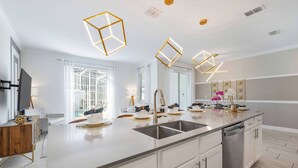 A modern kitchen with a large island, stainless steel appliances, and pendant lighting. - CG1086 - 4BR house with pool near Disney area (Davenport)
