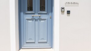 Une porte bleue avec une plaque portant l’inscription « Villa Kalliste ».