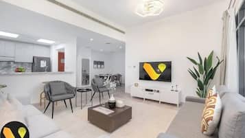 Luxury Apartment, Balcony, City View | Living area | 65-inch Smart TV with cable channels